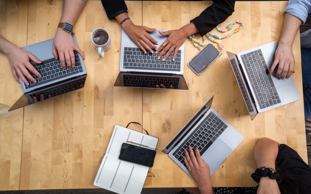 picture of people using laptops on table