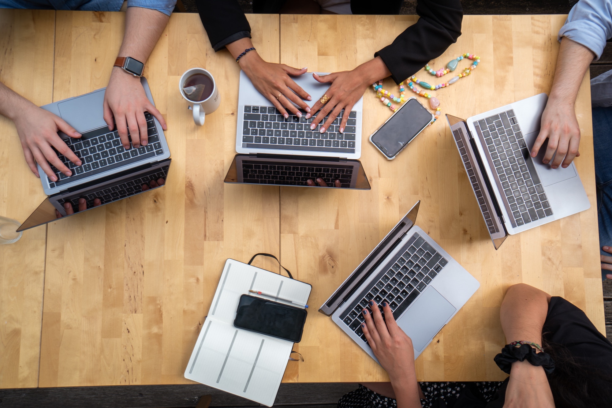 picture of people using laptops on table